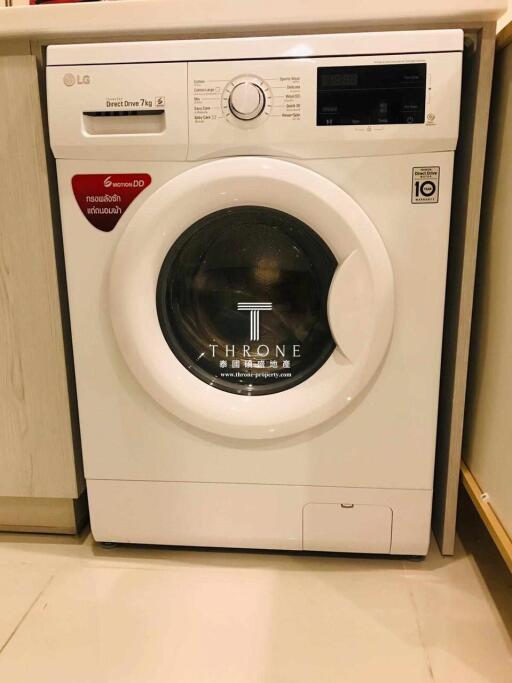 White front load washing machine in a home laundry room