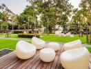 Modern outdoor sitting area with stylish furniture and lush greenery