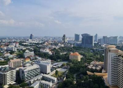 Aerial view of a cityscape with various buildings and distant water body