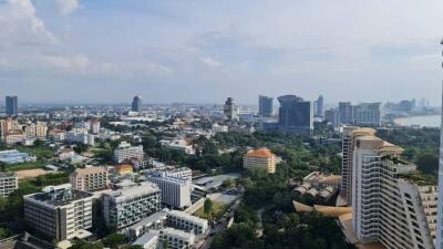 Aerial view of a cityscape with various buildings and distant water body