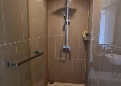 Modern bathroom with walk-in shower and beige tiles