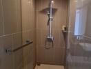 Modern bathroom with walk-in shower and beige tiles