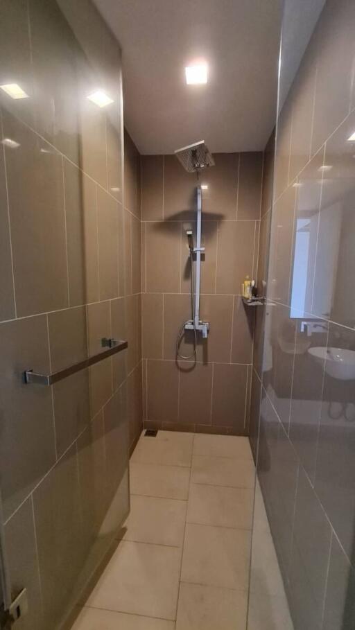 Modern bathroom with walk-in shower and beige tiles