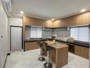 Modern kitchen with marble flooring and breakfast bar