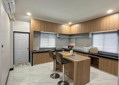 Modern kitchen with marble flooring and breakfast bar
