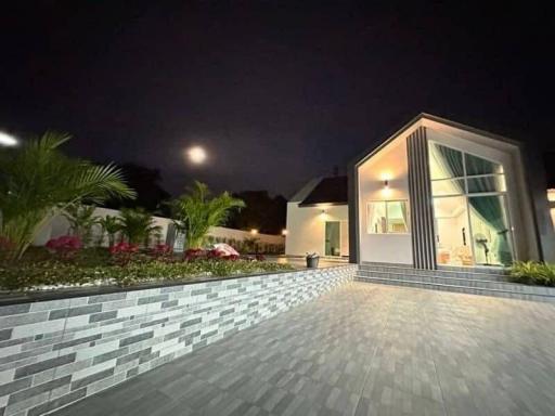 Modern house exterior at night with enhanced outdoor lighting