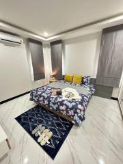 Spacious modern bedroom with sleek design and ample lighting
