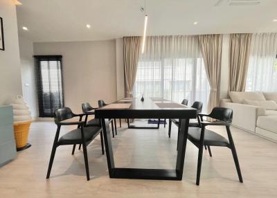 Spacious dining and living room with modern furniture and ample natural light