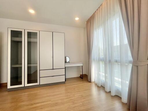 Spacious bedroom with modern wardrobe and ample natural light