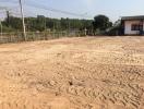 Vacant land ready for construction with fence and nearby buildings