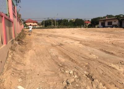 Unfinished outdoor area near construction site with dirt road
