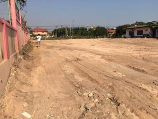 Unfinished outdoor area near construction site with dirt road