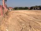 Unfinished outdoor area near construction site with dirt road