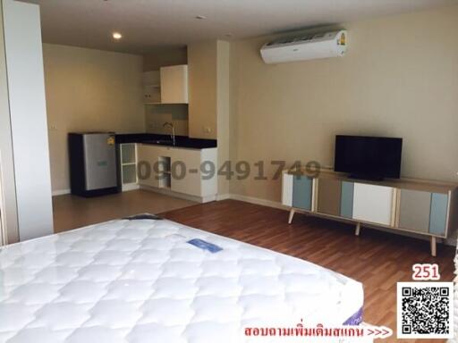 Compact studio apartment with combined living space, kitchen, and sleeping area