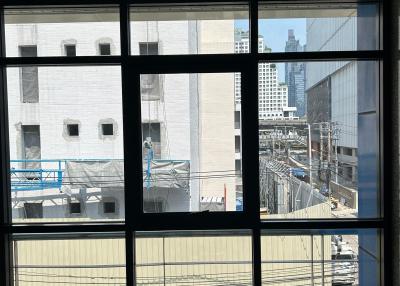 View from a modern window showing city buildings and construction