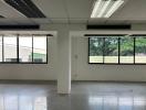 Spacious commercial building interior with large windows and plenty of natural light