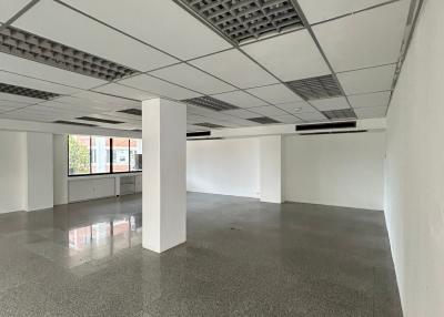 Spacious commercial space with large windows and reflective floor