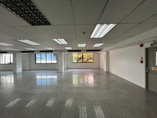 Spacious commercial office space with large windows and ample lighting