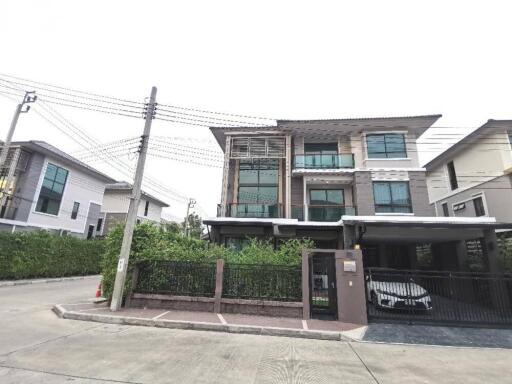 Exterior view of a modern two-story residential building with a balcony and garage