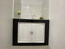 Modern bathroom sink with white cabinet and black countertop