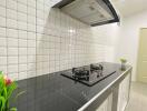 Modern kitchen with white subway tiles and black countertop