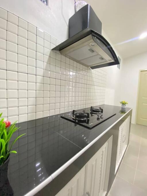 Modern kitchen with white subway tiles and black countertop