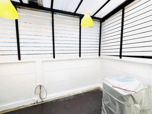 Empty space in a building with white walls and exposed ceiling beams