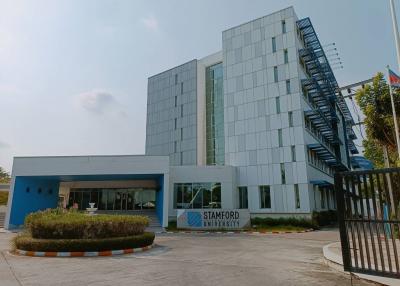 Modern university building facade with glass windows and blue accents