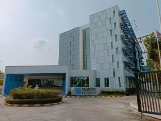 Modern university building facade with glass windows and blue accents