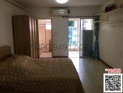 Cozy bedroom with balcony access and ample natural light