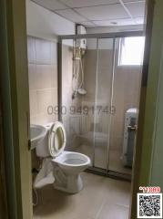 Compact bathroom with shower cabin and toilet