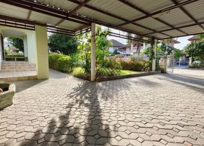 Spacious outdoor area with paving and lush greenery