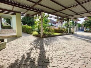 Spacious outdoor area with paving and lush greenery