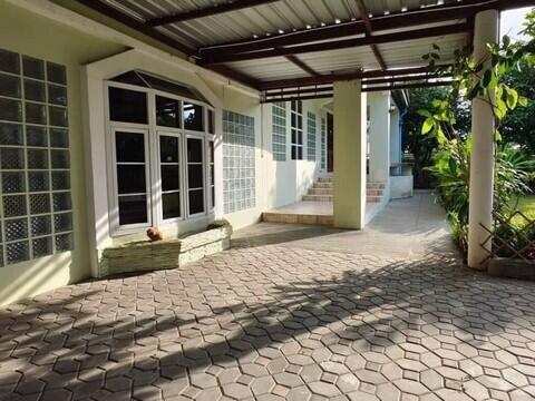 Spacious patio area with paving stones and shaded section