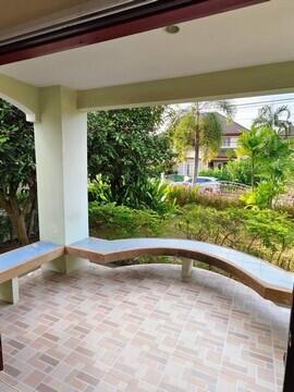 Spacious covered patio with tiled flooring and garden view
