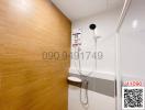 Modern bathroom interior with mounted shower and wooden accent wall