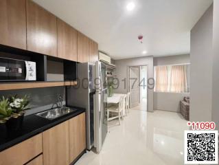 Modern kitchen with stainless steel appliances and open layout to dining area