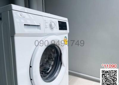 Modern LG washing machine in a clean and well-kept laundry room