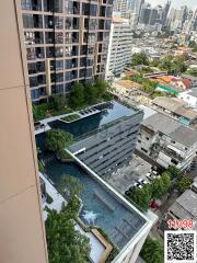 High-rise residential building with outdoor swimming pool and city view