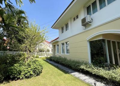 Well-maintained house exterior with garden and walkway