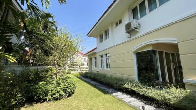 Well-maintained house exterior with garden and walkway