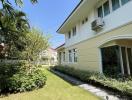 Well-maintained house exterior with garden and walkway