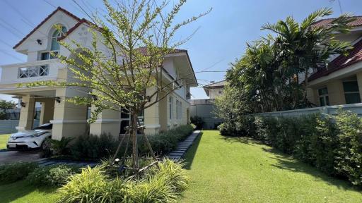 Spacious front yard of a residential property with lush green lawn