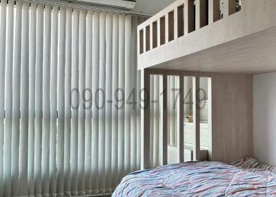 Modern bedroom interior with a raised platform bed and large windows