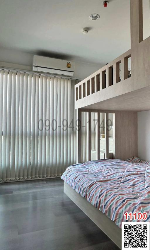 Modern bedroom interior with a raised platform bed and large windows