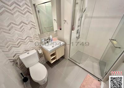 Modern bathroom with a walk-in shower and patterned wall tiles