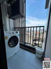 Compact laundry space with washing machine, drying system, and natural light