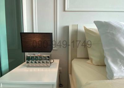 Modern bedroom with a side table and digital clock