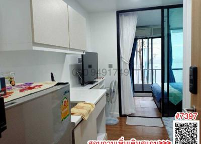 Compact studio apartment interior with integrated kitchen and sleeping area