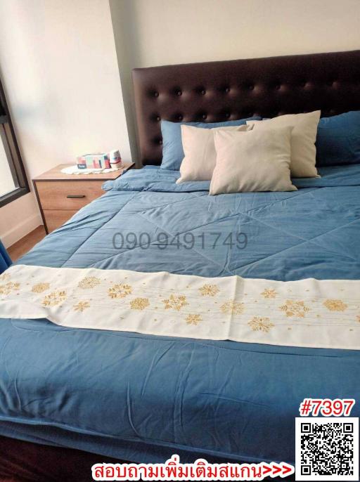 Cozy bedroom with a neatly made bed and wooden bedside table